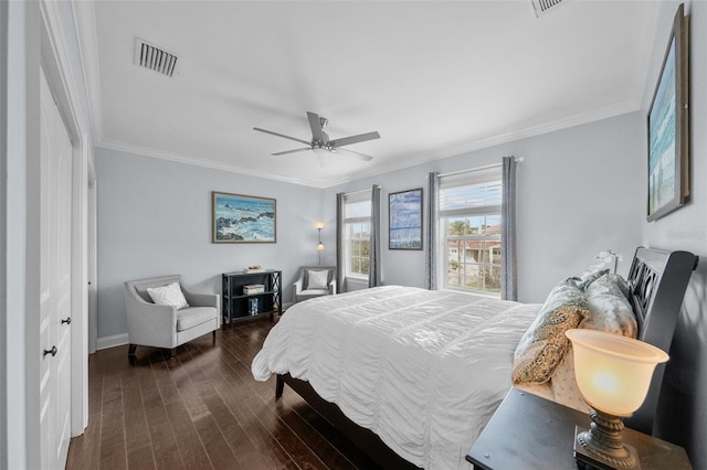 bedroom with a closet, crown molding, ceiling fan, and dark wood-type flooring