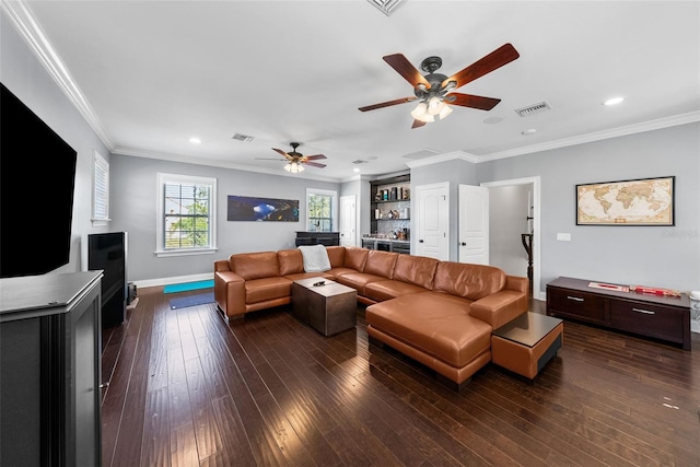 living room with dark hardwood / wood-style flooring, ceiling fan, and ornamental molding