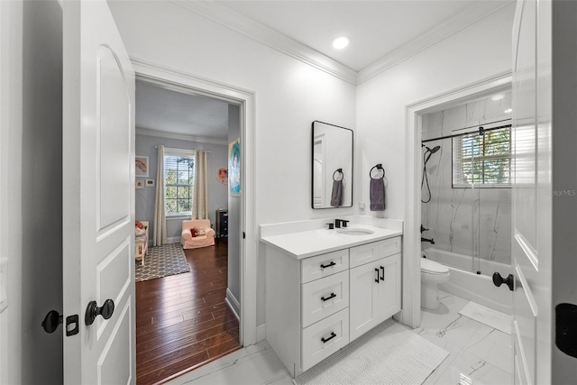 full bathroom with vanity, tiled shower / bath, wood-type flooring, and ornamental molding