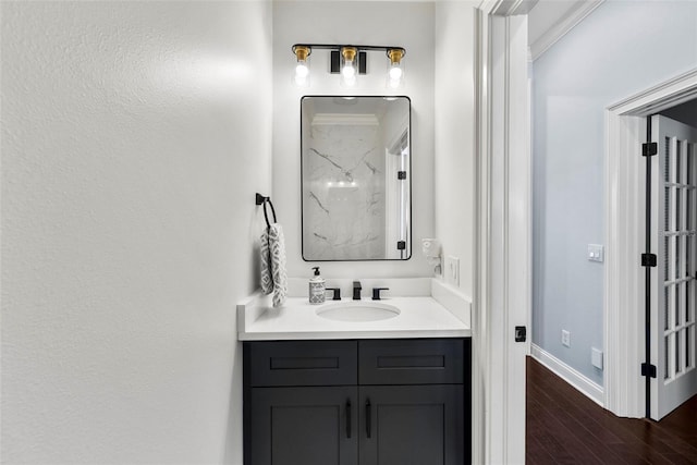 bathroom with hardwood / wood-style floors and vanity