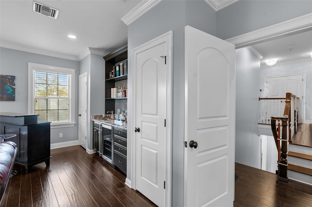 bar featuring dark hardwood / wood-style flooring and crown molding