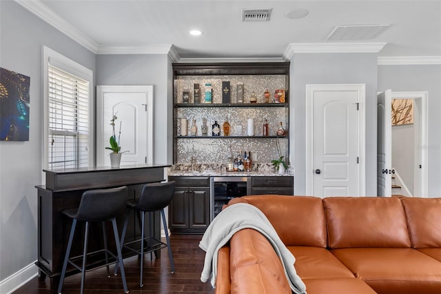 bar with dark hardwood / wood-style flooring, crown molding, wine cooler, and tasteful backsplash