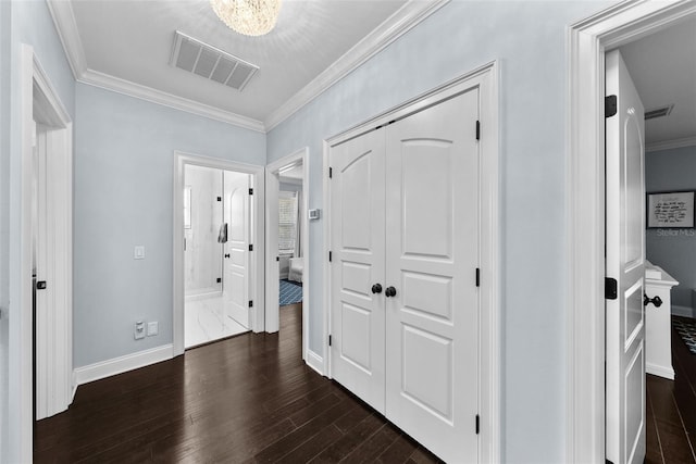 hall featuring ornamental molding and dark wood-type flooring