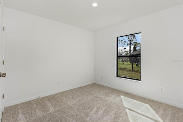 spare room featuring light carpet