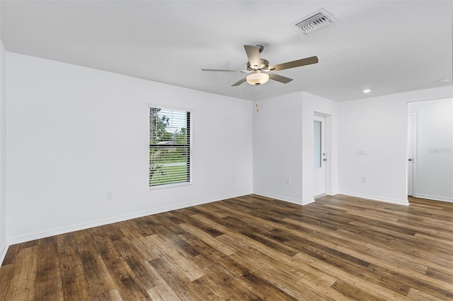 empty room with dark hardwood / wood-style flooring and ceiling fan