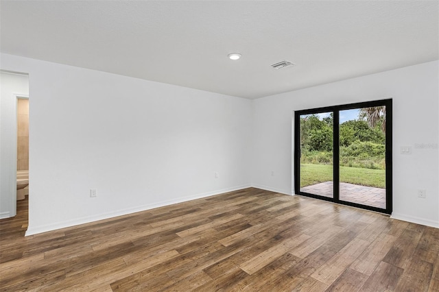 unfurnished room featuring dark wood-type flooring