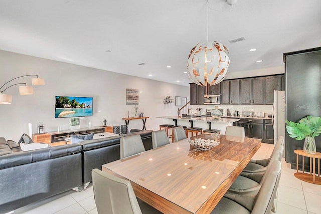 dining space featuring light tile floors