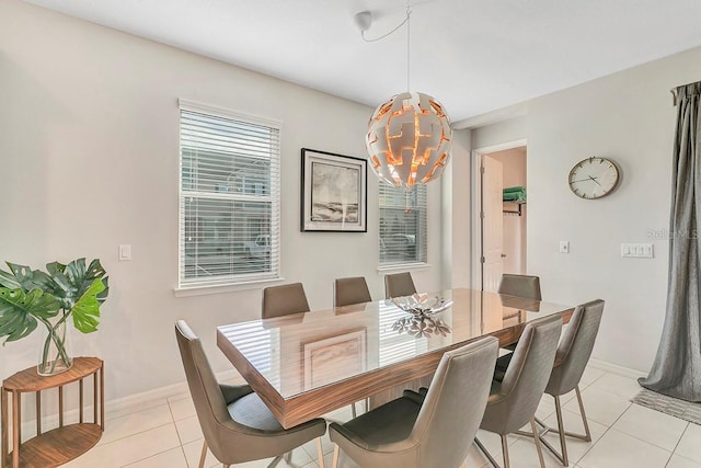 dining area featuring an inviting chandelier and light tile floors