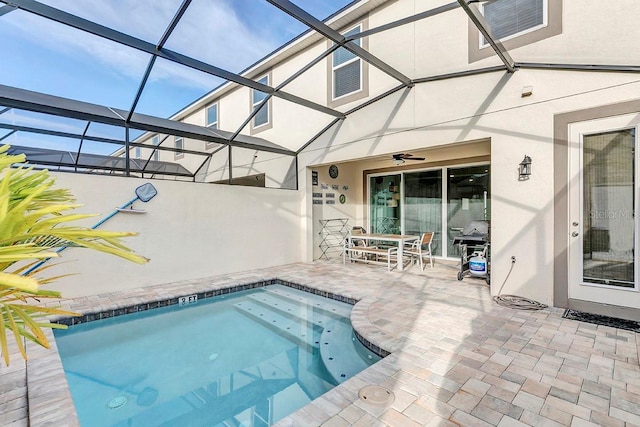 view of pool featuring a lanai, ceiling fan, and a patio