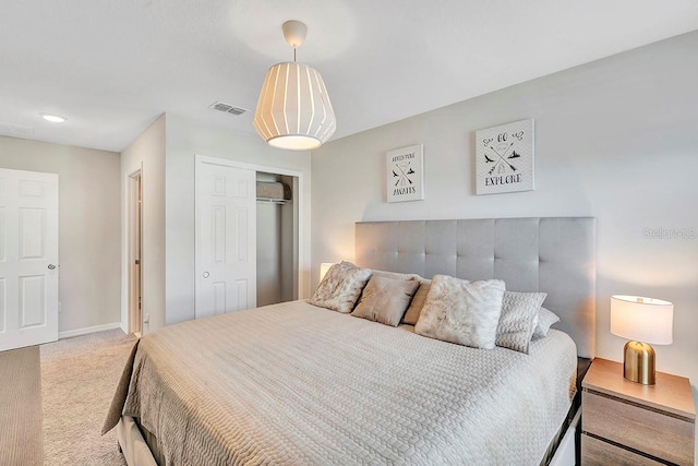 bedroom featuring light carpet and a closet