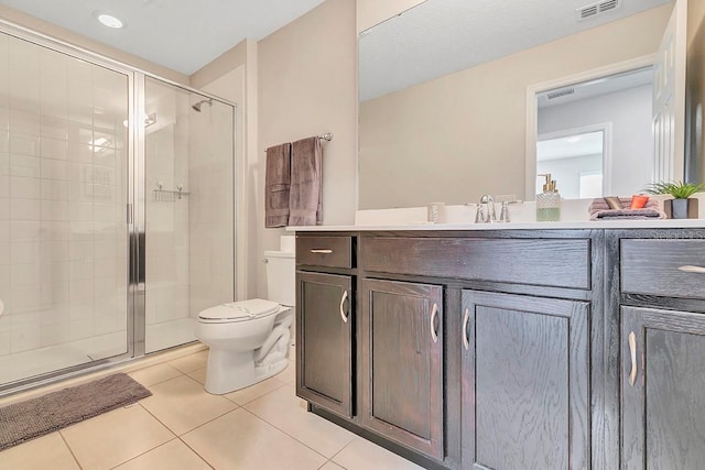 bathroom featuring toilet, tile floors, vanity, and an enclosed shower