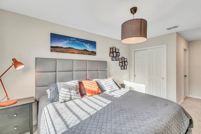 bedroom featuring light carpet and a closet