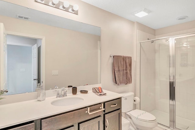 bathroom featuring walk in shower, a textured ceiling, large vanity, and toilet