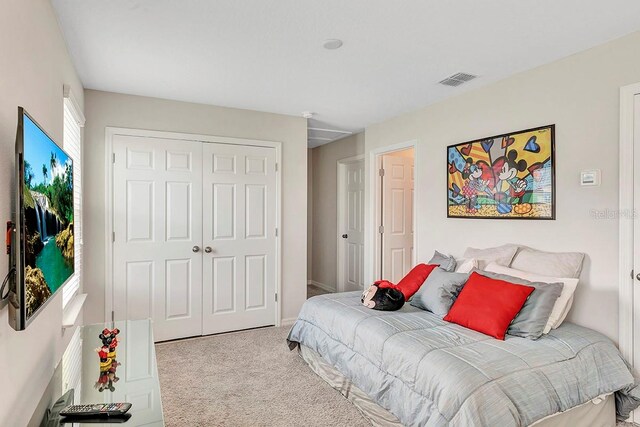 carpeted bedroom featuring a closet