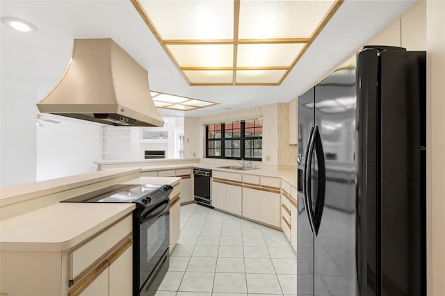 kitchen with island range hood, black appliances, kitchen peninsula, sink, and light tile floors