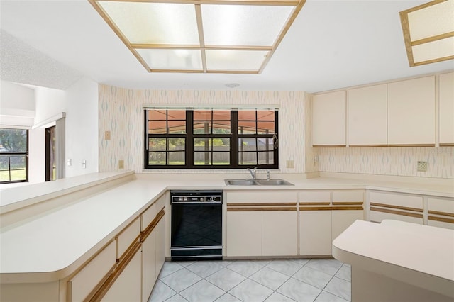 kitchen featuring sink, black dishwasher, kitchen peninsula, and light tile floors