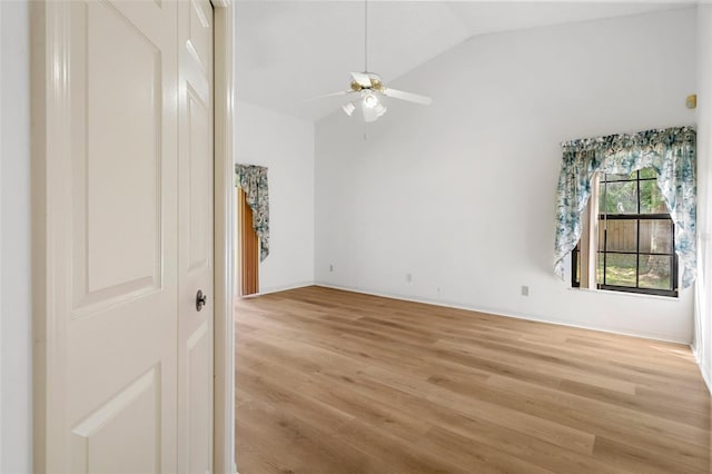 empty room featuring lofted ceiling, ceiling fan, and light hardwood / wood-style floors