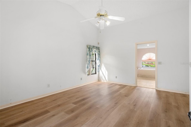 unfurnished room with high vaulted ceiling, ceiling fan, and light hardwood / wood-style floors