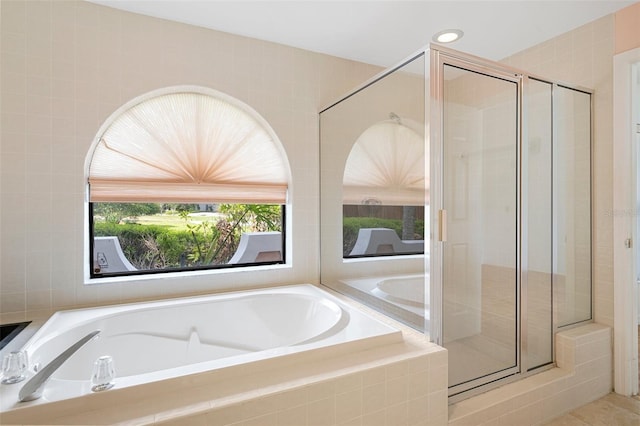 bathroom with tile floors and separate shower and tub