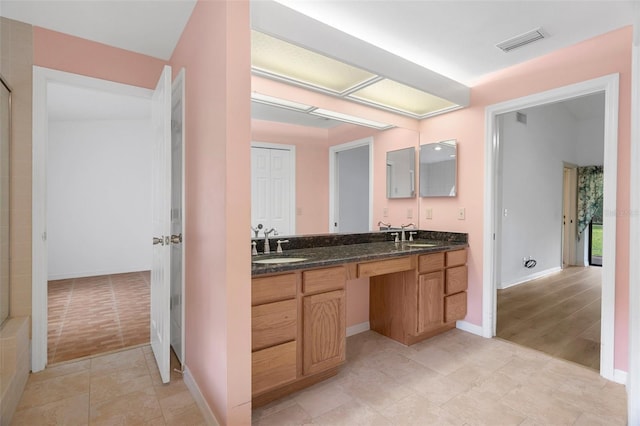 bathroom with double vanity and tile floors