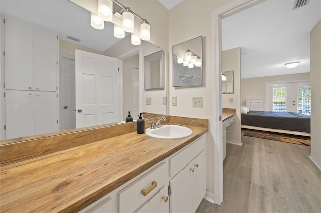 bathroom with vanity and hardwood / wood-style floors