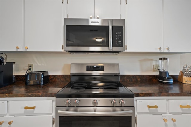 kitchen with stainless steel appliances and white cabinetry