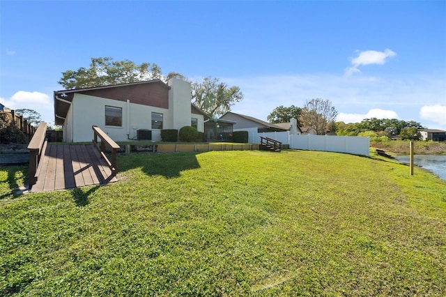 view of yard featuring central AC unit and a wooden deck