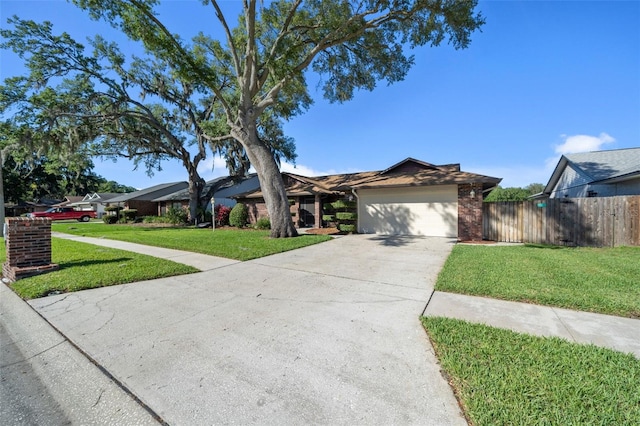 single story home featuring a garage and a front yard