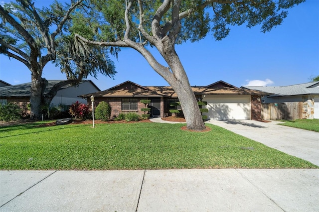 ranch-style home featuring a front yard and a garage