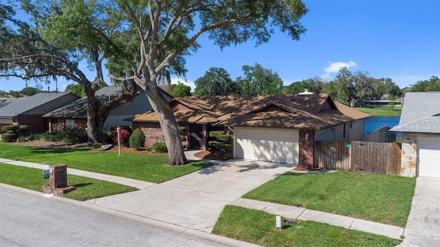 view of front of house featuring a front yard and a garage