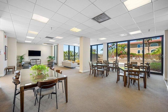 dining space with a drop ceiling