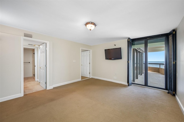 empty room with light colored carpet