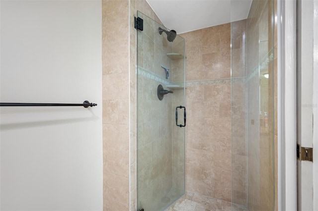 bathroom featuring a shower with door