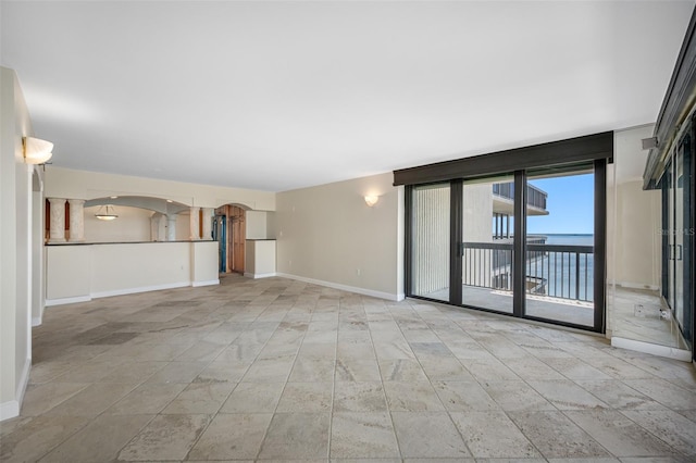 unfurnished living room with a water view