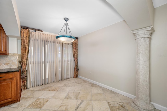 unfurnished dining area with ornate columns