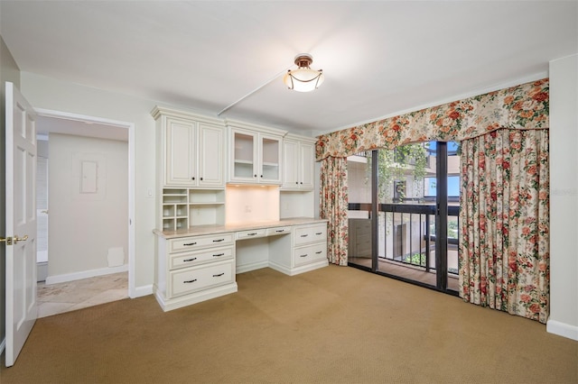 unfurnished office with built in desk and light colored carpet