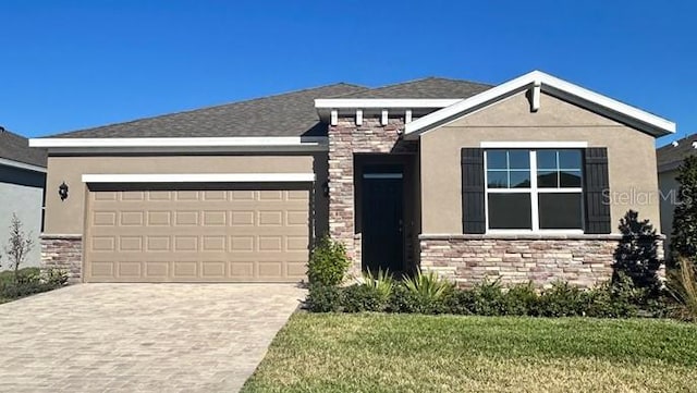 view of front of home with a garage and a front yard