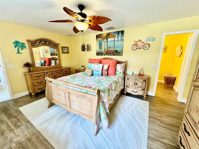 bedroom with ceiling fan and light hardwood / wood-style floors