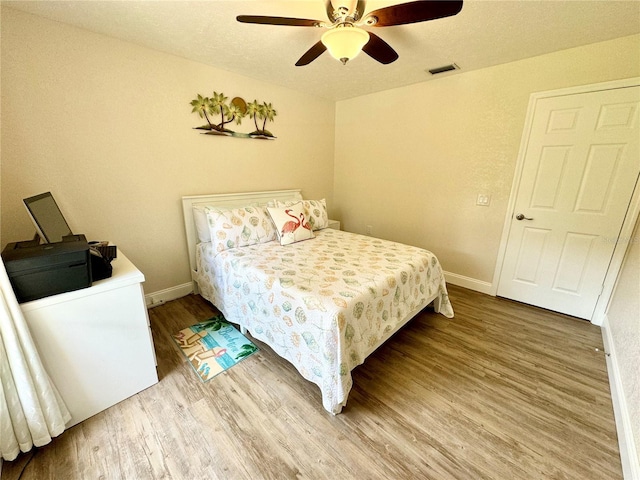 bedroom with hardwood / wood-style floors and ceiling fan