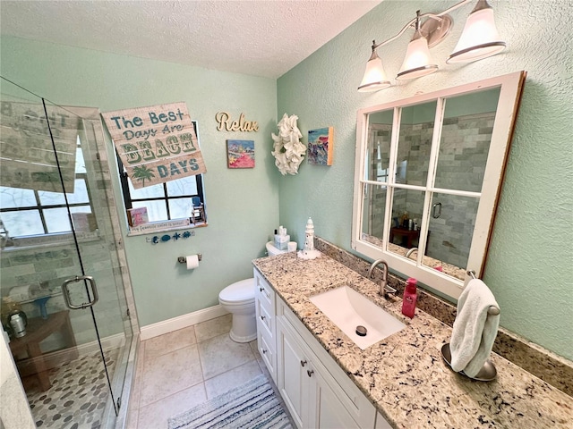 bathroom featuring vanity, a textured ceiling, toilet, and walk in shower