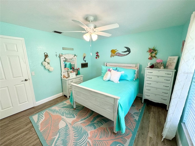 bedroom with ceiling fan and dark hardwood / wood-style flooring