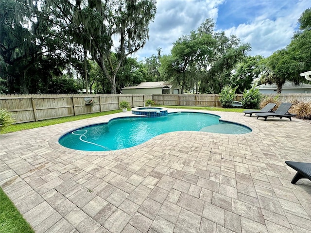 view of pool with an in ground hot tub and a patio