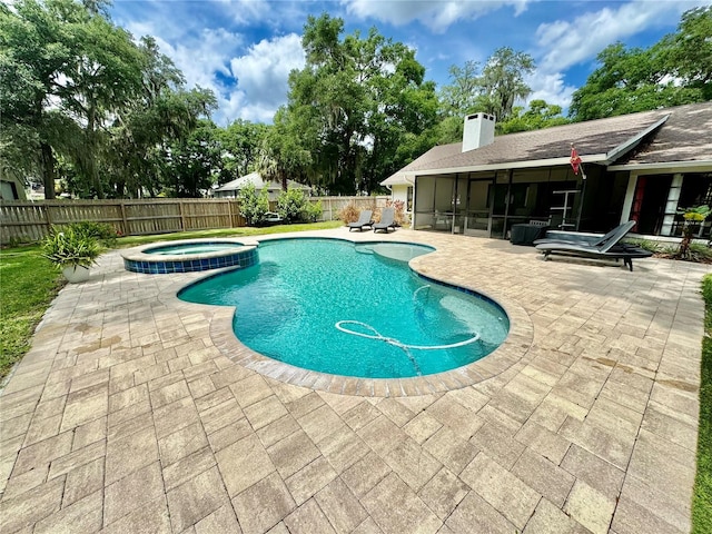 view of swimming pool with an in ground hot tub, a patio, and a sunroom