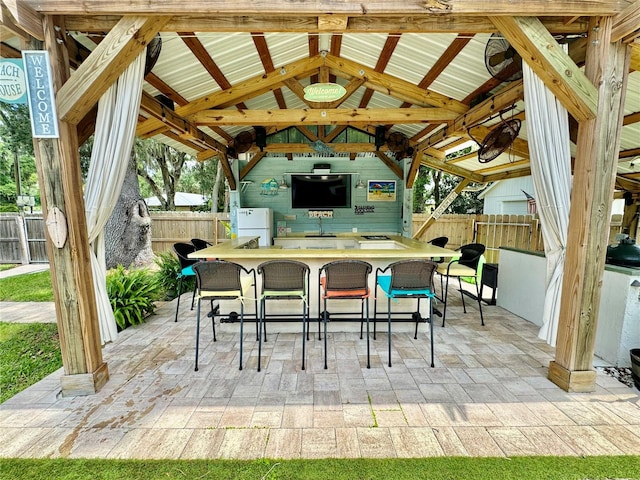 view of patio with a gazebo and an outdoor bar