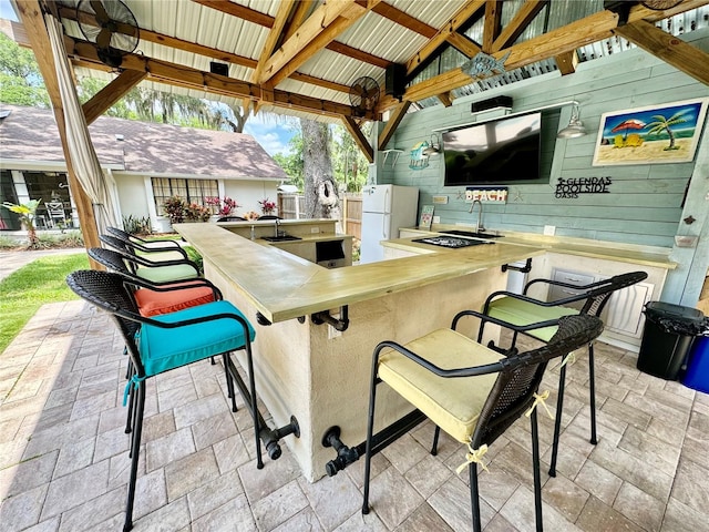 view of patio / terrace featuring a gazebo, ceiling fan, and a bar