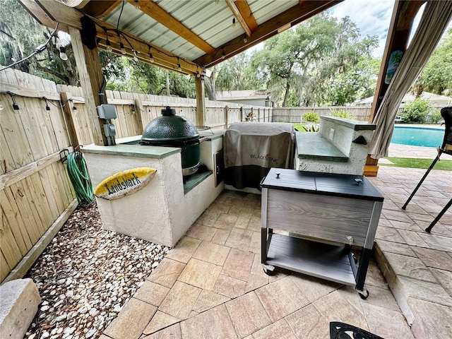 view of patio featuring grilling area and exterior kitchen