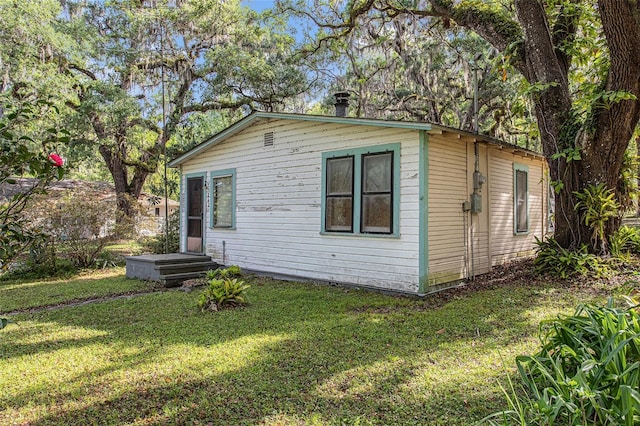 view of home's exterior with a lawn