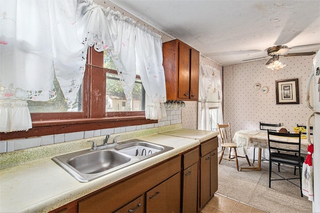 kitchen with ceiling fan, sink, and light tile floors