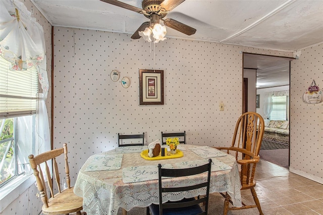 dining room with ceiling fan and light tile floors