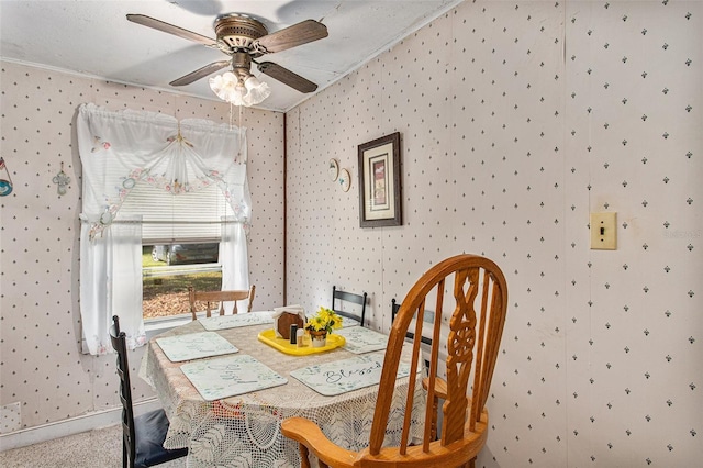 carpeted dining area with ceiling fan